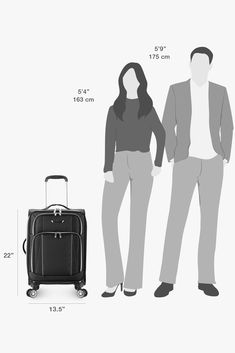 a man and woman standing next to each other in front of a black luggage bag