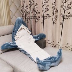 The shark blanket is made from soft and cozy materials, typically a combination of polyester and fleece. This ensures that the wearer stays warm and comfortable while using the blanket. One of the main attractions of the wearable shark blanket is its ability to spark imagination and creativity. It allows the wearer to pretend to be a shark, adding an element of playfulness and fun to everyday activities. It can also be a great gift option for shark enthusiasts or those who enjoy unique and quirk Shark Sleeping Bag, Shark Onesie, Shark Blanket, Shark Pajamas, Shark Costumes, Shark Gifts, Flannel Hoodie, Shark Lover, Cute Shark