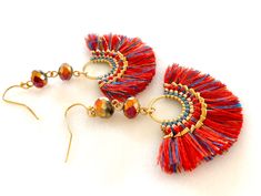 "\"Festival\" woven red and gold fan tassel earrings with Chinese Thunder Polished iridescent crystals on gold plated French hooks. Fun lightweight tassels are woven in red, gold and light and dark blue with intricate woven boarder of genuine Miyuki seed beads. Tassels are 50 x 30mm. Chinese Thunder Polished 8 x 6mm faceted rondelles in metallic gold and fuchsia are wire wrapped above for extra bling! Tassels hang from gold plated French hooks. Total length is 2 1/2\". These are very lightweight Paris Charm Bracelet, Beads Tassels, Iridescent Crystal, Personalized Quilt, Gifts For An Artist, Red And Gold, Tassel Earrings, Metallic Gold, Red Gold