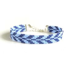 a bracelet with blue and white squares on it