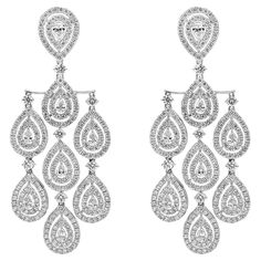 A brilliant pair of earrings showcasing pear shape diamonds, surrounded by two row of double halo round brilliant diamonds weighing 9.25 carats total. Set in a chandelier design and Finely made in 18k white gold. Style available in different price ranges. Prices are based on your selection. Please contact us for more information. Halo Chandelier, Chandelier Contemporary, Boho Bridal Jewelry, Double Halo, Chandelier Design, Boho Bridal, Pear Shaped Diamond, Diamond Halo, Brilliant Diamond