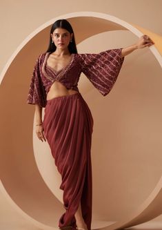 Layers for this season? This ethnic maroon jacket set is a perfect ensemble makes it possible with a lightweight organza cape, drape dhoti pleated style skirt and cropped blouse with hand embroider... Ruffle Skirt Pattern, Maroon Skirt, Maroon Jacket, Trendy Outfits Indian, Set Saree, Fabric Skirt, Beads Embroidery, Padded Blouse, Outfits Woman