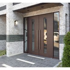 an entrance to a building with two brown doors