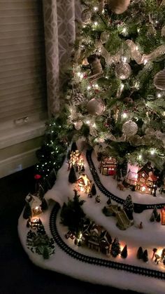 a christmas tree with train tracks and lights