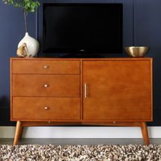 a television sitting on top of a wooden cabinet