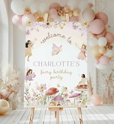 a welcome sign surrounded by balloons and other decorations for a fairy themed birthday party in pastel colors