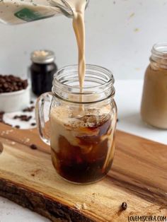 coffee being poured into a mason jar