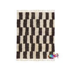 a brown and white rug with black squares on it