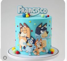 a blue cake decorated with cartoon characters and the words franisco on it's side