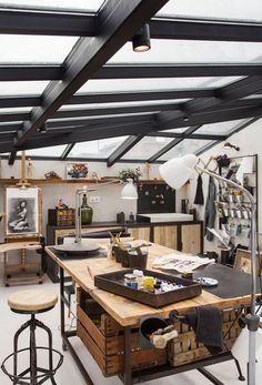 an open kitchen with lots of counter space and stools on the floor in front of it