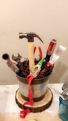 a bucket filled with tools sitting on top of a table