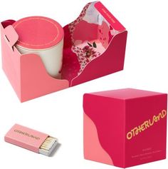 an open pink box with a cup inside