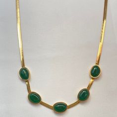 This elegant Gold Plated Snake Chain Faux Emerald Necklace adds a touch of sophistication to any outfit. Featuring a stunning faux emerald pendant, this necklace is perfect for women who want to make a statement. The gold plating adds a touch of luxury, while the snake chain design adds a unique and stylish touch. Material: Brass Necklace Size: 15.0"+2.2"Extension Chain Elegant Green Oval Necklace, Green Oval Necklace For Formal Occasions, Formal Green Oval Necklace, Elegant Green Gold-plated Necklace, Elegant Green Gold Plated Necklace, Elegant Green Clavicle Chain Necklace, Classic Green Jeweled Necklace, Gold Emerald Necklace With Clavicle Chain For Formal Occasions, Green Formal Jewelry Chain