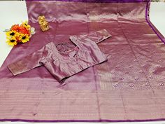 Elegant Silk Saree with intricate weaving work, accompanied by an unstitched running blouse and a FREE designer blouse, Perfect for Weddings/Parties. FABRIC : SOFT SILK CLOTH DESIGN : BEAUTIFUL PALLU AND DESIGN ON ALL OVER THE SAREE. BLOUSE : BEAUTIFUL  STITCHED DESIGNER BORDER BLOUSE WITH DANGLINGS. Color:Light Magenta Saree: Fabric. :- Soft Silk Work :- Weaving Cute :- 5.5 mtr Blouse: Fabric:- Phantom Silk. with Fancy Border and designer work Work :- Embroidery thread work  Chest :-38 inches with margin on either sides(Can be altered 34-42 inches) Stitch Type: stitched Wash Instruction:- Dry Clean Only Occasion: Wedding Wear, Party Wear, Gifts for Her,Festive Wear, Engagement Wear, Mehndi Wear, Casual Wear Unstitched Purple Blouse For Eid, Purple Self Design Blouse For Eid, Zari Weaving Long Sleeve Blouse Piece For Eid, Semi-stitched Blouse With Traditional Patterns For Eid, Long Sleeve Blouse Piece With Zari Weaving For Eid, Semi-stitched Cotton Silk Purple Blouse Piece, Unstitched Purple Cotton Silk Saree, Semi-stitched Purple Chinon Saree, Festive Purple Cotton Silk Pre-draped Saree