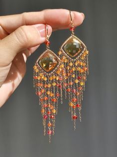 This is a pair of exquisite natural Citrine, and I have crafted exquisite frames for them. I have used high-quality Fanta garnet, Padparadscha sapphire, and red spinel to create tassels, which shine brilliantly in the sunlight, like a romantic sunset. ●Citrine ●Fanta garnet ●Padparadscha sapphire ●red spinel ●14k gold filled ●total length approximately: 3.89 inches ●weight：6.5g Welcome to visit my Jewelry store: https://www.etsy.com/shop/Ukuly 🌸The delivery time to Most regions of North America, Australia and Europe is usually about 10-15 days. Buyers from Brazil, South Korea, and Indonesia, please provide me with your tax number through messages or notes for smooth shipment. Thank you. 🌸Please let me know your phone number when you place an order. It will be used for shipping label only Orange Gemstone Dangle Earrings, Elegant Orange Earrings With Natural Stones, Orange Gemstone Dangle Jewelry, Fusion Style Chandelier Earrings With Dangling Beads, Elegant Orange Chandelier Earrings For Gift, Elegant Orange Chandelier Earrings Gift, Fusion Style Dangling Beads Chandelier Earrings For Gift, Orange Dangle Earrings With Natural Stones, Orange Fine Jewelry With Matching Earrings