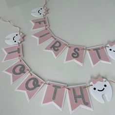 a pink and silver banner that says teeth, teeth are spelled out with white letters