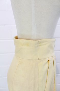 "This is a lovely pair of vintage 80s linen high waist Bermuda shorts. The longer length makes them perfect for business casual looks, and the bright cream linen is summery and fresh. Wear them with a crisp button up blouse or a simple t-shirt for a relaxed yet chic outfit. The waistband is nice and wide with a double button closure, and the legs are cuffed. COLOR: Cream MATERIAL: Linen CONDITION: Overall excellent, but there are two small yellow marks at the top of the waistband on the right si Fitted Knee-length Linen Bottoms, Fitted Linen Knee-length Bottoms, Cream High-waisted Fitted Shorts, Cream Fitted High-waisted Shorts, Cream Linen Bottoms For Summer, Fitted Linen Bottoms For Daywear, Vintage Workwear Shorts For Summer, Vintage Summer Workwear Bottoms, Fitted Beige Casual Shorts