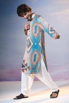 Blue and multi color full sleeves kurta with Tapiz tribe print all over and sequin highlights. Paired with an off white salwar. - Aza Fashions Navratri Long Sleeve Sherwani With Mirror Work, Long Sleeve Sherwani With Mirror Work For Navratri, Traditional Bandhgala With Long Sleeves And Printed Motifs, Traditional Long Sleeve Bandhgala With Printed Motifs, Long Sleeve Bandhgala With Printed Motifs For Eid, Multicolor Embroidered Long Sleeve Kurta With Mirror Work, Long Sleeve Blue Sherwani For Navratri, Multicolor Long Sleeve Bandhgala For Diwali, Blue Long Sleeve Sherwani For Navratri