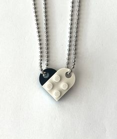 Matching BFF Heart Friendship Necklace Set - Made with authentic LEGO® Bricks!We never use fake/imitation bricks. Everything is authentic.**SHIPS NEXT BUSINESS DAY** This beautiful set contains 2 very high-quality made-in-USA ball chain necklaces that will make a whole heart. Chains are 24" long. LEGO® Brick is ~5/8" wide x ~1" long.*Please review "Shipping & Policies" section. *Not recommended for children under 10. These products are made using LEGO® elements. LEGO®, and the LEGO logo, are