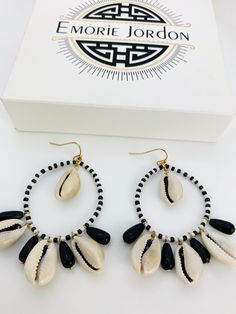 Make your way to the next music festival in these gorgeous earrings. Made of authentic cowrie shells and seed beads. Black Shell Jewelry For Gifts, Black Shell Jewelry Gift, Black Shell Jewelry As A Gift, Bohemian Earrings With Ear Wire For Vacation, Bohemian Beaded Earrings For Vacation, Black Hoop Earrings For Summer Gift, Black Dangle Jewelry For Beach, Black Dangle Jewelry For Summer, Black Drop Earrings For Summer