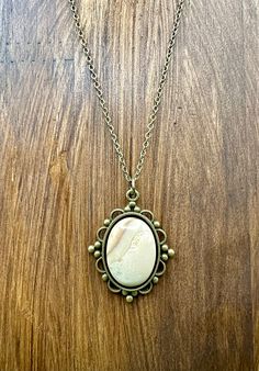 Looking for a necklace that exudes elegance and class while also offering a calming vibe? Look no further than the Tranquil Vibes Agate Cabochon Mounted on Antique Bronze Setting 18" Necklace!  Crafted by the experts at Dystracted Metaphysical, this necklace is perfect for adults who seek balance and harmony in their lives. The 18x13mm agate cabochon, mounted on an antique bronze colored zinc alloy bezel tray, symbolizes strength, protection, and courage. Its calming vibe is sure to soothe your senses and offer a sense of tranquility. At 18 inches in length, this necklace chain is the perfect accessory to wear with any outfit - from everyday wear to formal events. With its unique blend of functionality and style that seamlessly blends elegance with tranquility - this Agate Cabochon Necklac Vintage Gemstone Necklace With Oval Cabochon, Agate Oval Pendant Necklace For Gifts, Elegant Bronze Oval Necklace, Elegant Oval Bronze Necklace, Gold Agate Oval Pendant Necklace, Agate Long Necklace Gift, Gold Agate Necklace With Large Stone, Elegant Agate Necklace With Large Pendant, Gold Agate Necklace With Oval Pendant