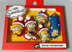 the simpsons christmas ornaments are on display in a box