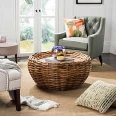 a living room with wicker furniture and white walls