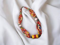 Elevate your style with our stunning Berber Necklace, inspired by the rich heritage of the Tuareg people. Crafted with exquisite detail, this necklace features a captivating array of multi-colored stones accented with vibrant coral, echoing the vibrant spirit of North African craftsmanship. Each bead tells a story of cultural significance, celebrating the resilience and beauty of Berber tradition. Whether you're adding a pop of color to your everyday look or seeking a statement piece for special Traditional Multicolor Necklace With Faceted Beads, Bohemian Red Beads, Gems, And Cabochons, Traditional Multicolor Faceted Beads Jewelry, Bohemian Multi-strand Necklace With Spacer Beads, Bohemian Oval Bead Jewelry For Festivals, Traditional Multicolor Jewelry With Faceted Beads, Bohemian Festive Jewelry With Faceted Beads, Bohemian Jewelry With Faceted Beads For Festive Occasions, Multicolor Faceted Beads Necklaces For Festivals