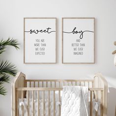 two framed posters on the wall above a crib in a baby's room