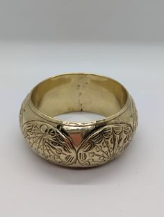 Beautiful! Vintage handmade brass  bangle bracelet. Fancy embossed design. Brass is bright, has been polished.  Some patina on the inside. Measurements : Outer diameter is 8.3 cm,  inner diameter is 6.5cm and  bracelet width is 3.7cm Very good vintage condition. Weighs 59g Engraved Brass Bangle Cuff Bracelet, Engraved Bronze Brass Bangle, Traditional Gold Stamped Bracelet, Gold Bohemian Etched Cuff Bracelet, Brass Bracelet With Intricate Design, Bohemian Metal Bangle With Engraved Details, Brass Bracelets With Intricate Design, Ceremonial Engraved Brass Cuff Bracelet, Bohemian Gold Etched Cuff Bracelet