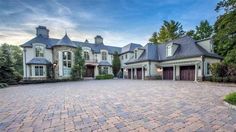 a large brick driveway in front of a house