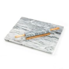 a marble cheese board with two wooden skewers