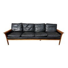 a black leather couch sitting on top of a wooden frame