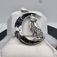 This 925 Sterling Silver Celtic Wolf Crescent Moon Pendant is a mystic emblem of intuition and transformation, crafted with a soulful Celtic twist. The pendant displays a howling wolf, intricately adorned with Celtic knotwork, poised within a sleek crescent moon embedded with black zircon stones that add a touch of nocturnal sparkle. The Celtic wolf is a symbol of guidance and guardianship, while the crescent moon represents the cycles of change and renewal. Together, they form a powerful amulet Mystical Sterling Silver Jewelry, Mystical Engraved Silver Jewelry, Mystical Sterling Silver Jewelry Stamped 925, Moon Phase Spiritual Jewelry, Spiritual Moon-shaped Collectible Jewelry, Wolf Symbolism, Celtic Wolf, Mystical Jewelry, Celtic Mythology