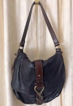 Cole Haan Soft Buttery Black Leather with brown trim satchel handbag Antique Brass details Magnetic snap closure Brown fabric liner in excellent shape Interior zipper pocket 14”W  x 12” H x 3”D Strap drop: 11” Longer add on strap not included Excellent shape from smoke & pet free home Vintage Leather-backed Hobo Satchel Bag, Vintage Black Hobo Shoulder Bag, Black Vintage Hobo Shoulder Bag, Vintage Hobo Bag With Adjustable Double Handle, Vintage Black Crossbody Hobo Bag, Vintage Leather-backed Hobo Bag For Travel, Vintage Black Hobo Bag, Vintage Black Hobo Bag For Daily Use, Vintage Leather Hobo Bag For Travel