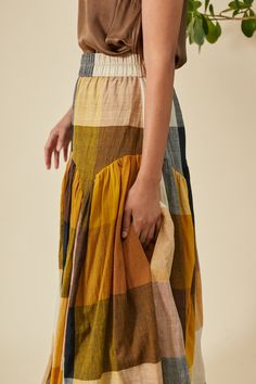 High waisted gathered, maxi skirt with scalloped, gathered drop waist and wide elastic waist band. This skirt has beautiful movement with it's full sweep. Model 5'8 | Size S 100% Hand Loomed Cotton Designed In New York | Handcrafted In India This garment is comfortable fit with an elastic waist. Questions about the fit? email us at help@rujutasheth.com Click here for sizes corresponding to body measurements *ALL MEASUREMENTS BELOW ARE GARMENT MEASURED ON THE FLAT * SIZE WAIST HIPS LENGTH XS 28”- Rujuta Sheth, Woven Wrap, Outerwear Sweater, Hand Loom, Drop Waist, Hip Length, Body Measurements, Long Skirt, Jumpsuit Dress