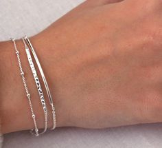 Simple and beautiful, this sterling silver bar bracelet is the perfect minimalist piece. It features a round curved bar attached to a fine chain. Wear it on its own or layer with other pieces from our collection and it's adjustable! 💖 Details 925 Sterling Silver Length 2 sizes:  Small/Medium: 16.5 - 19 cm including 2.5 cm extension Medium/Large: 18 - 20.5 cm including 2.5 cm extension The other bracelets pictured are not included but are available on Etsy or my online store 💕 Online store: www.thejewellerytree.net 💕 Stay up-to-date with new designs & special offers  - FOLLOW ME   Socials: @myjewellerytree OR  https://www.facebook.com/thejewellerytree1/  💕 Need more info, feel free to email - I'd love to help 💕And please visit my store https://www.etsy.com/au/shop/TheJewelleryTreeCo to Sterling Silver Stackable Chain Bracelet, Sterling Silver Bracelet With Delicate Chain For Everyday, Delicate Chain Sterling Silver Bracelet For Everyday, Everyday Sterling Silver Bracelet With Delicate Chain, Minimalist Stackable Silver Chain Bracelet, Sterling Silver Satellite Chain Bracelet For Everyday, Minimalist Sterling Silver Satellite Chain Bracelet, Everyday Sterling Silver Chain Bracelet With Satellite Chain, Everyday Sterling Silver Satellite Chain Bracelet