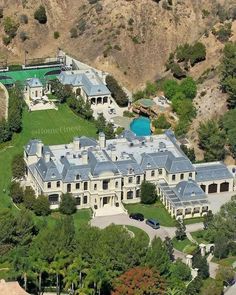 an aerial view of a mansion in the hills