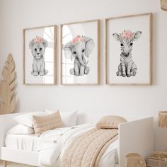 three framed pictures hang on the wall above a bed in a room with white walls