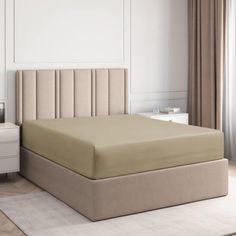 a bed with a beige headboard and foot board next to a white dresser in a bedroom