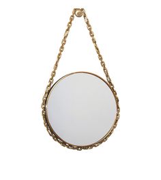 a round mirror hanging from a chain