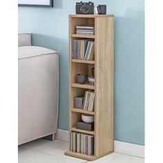 a bookshelf with various items on top of it in front of a blue wall