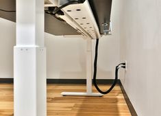 an electrical device is plugged into the wall next to a wood floor and white walls