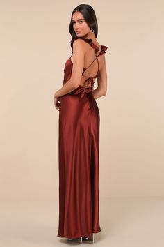 The Lulus Exuberant Luxury Rust Satin Ruffled Lace-Up Maxi Dress was made for any special occasion that needs a sensational look to match! Sleek woven satin shapes this lovely dress that features a sleeveless bodice with a ruched detail at the center, creating chic pleating and a sweetheart neckline. Slender, ruffle-trimmed straps flow into a trendy lace-up design across an open back. The high, empire-style waist tops a figure-skimming, A-line skirt that cascades down to a sweeping maxi hem. Hid Satin Bridesmaid Evening Dress Bias Cut, Bridesmaid Satin Evening Dress With Bias Cut, Satin Bias Cut Bridesmaid Evening Dress, Satin Prom Dress With Satin Bow, Formal Satin Finish Slip Dress For Prom, Satin Finish Modal Satin Slip Dress For Prom, Glamorous Satin Dress With Satin Bow, Prom Season Satin Evening Dress With Bias Cut, Glamorous Satin Gown With Bias Cut