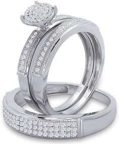 two white gold wedding rings with diamonds on each band and an engagement ring in the middle