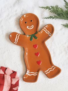 a ceramic ginger ornament with hearts on it next to a red and white napkin