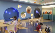 the children's playroom is decorated in blue and white colors with colorful circles on the wall