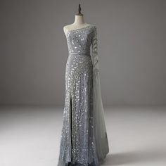 an evening gown with sequins is displayed on a mannequin