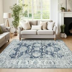 a living room filled with furniture and a large rug on top of a hard wood floor