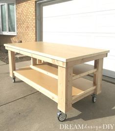 a wooden table sitting on top of a sidewalk next to a garage door and a brick building